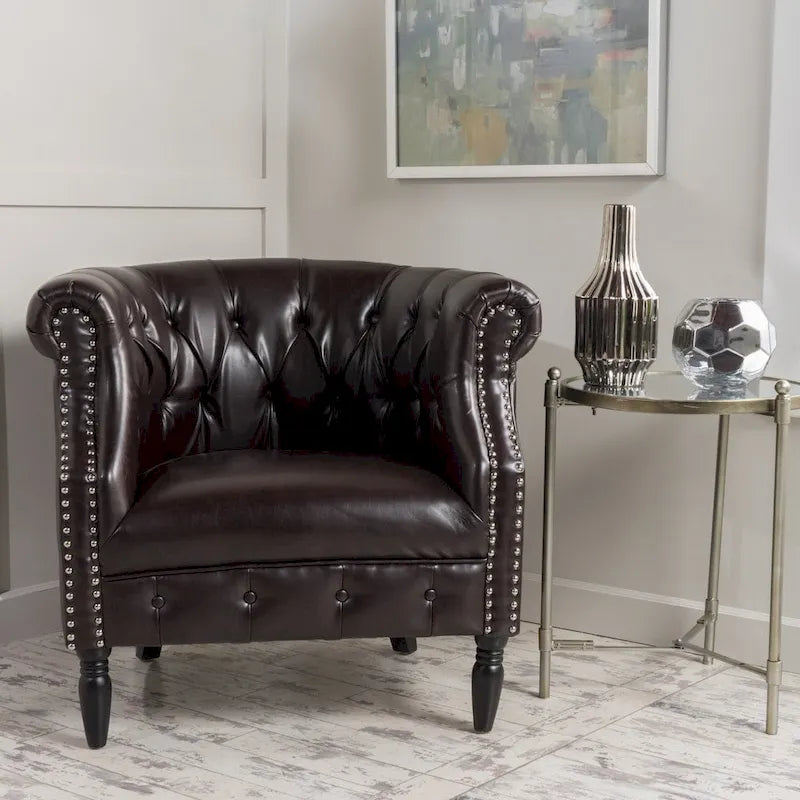 Fauteuil club capitonné en similicuir collé