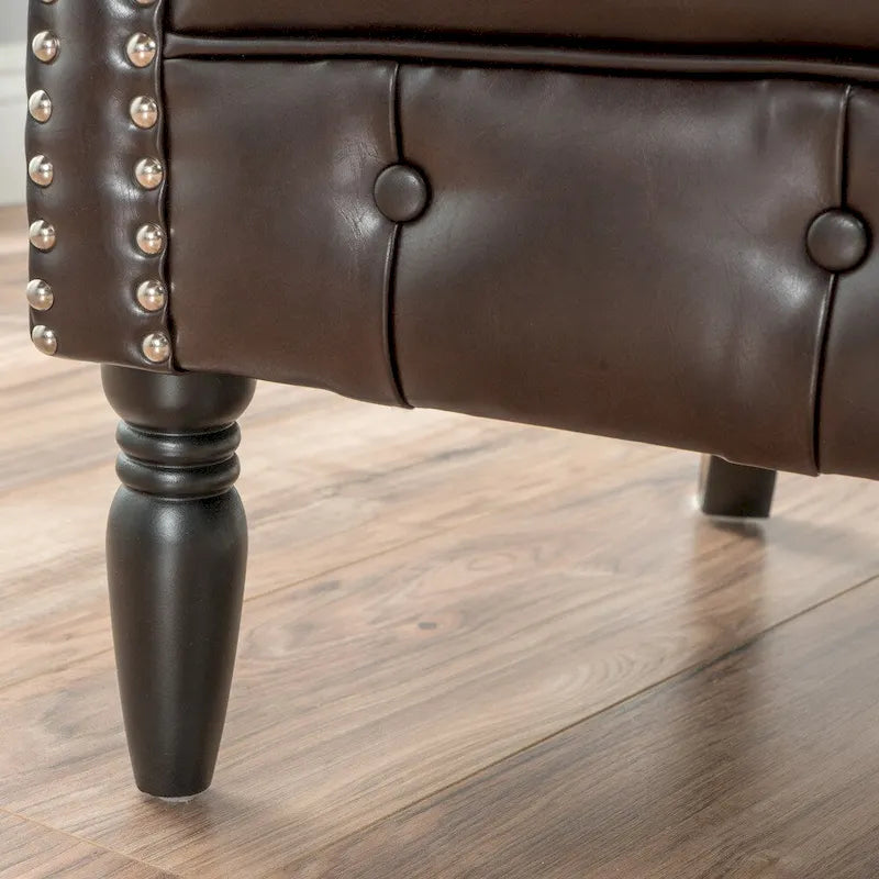 Fauteuil club capitonné en similicuir collé