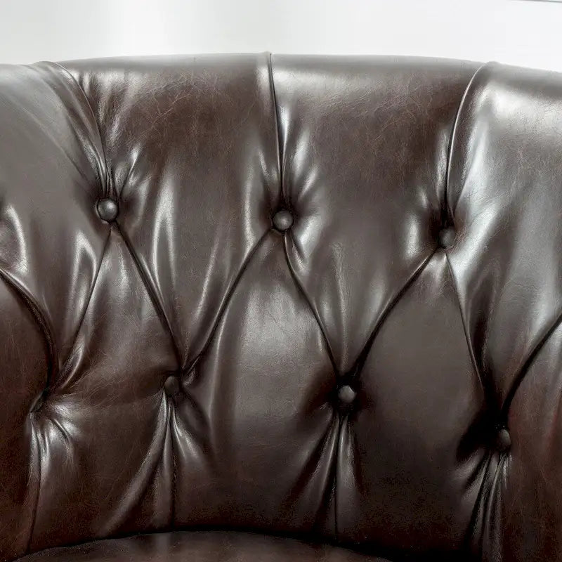 Fauteuil club capitonné en similicuir collé